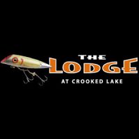 Logo for The Lodge at Crooked Lake featuring a fishing lure and bold orange and white text on a black background.