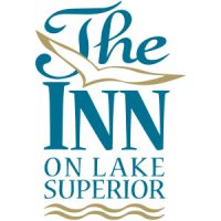 Logo for The Inn on Lake Superior, featuring stylized text and a bird above blue waves.